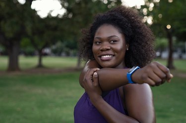 Smiling curvy woman stretching