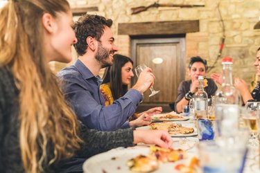 Friends eating pizza together and having fun