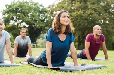 A group of people practicing yoga outdoors