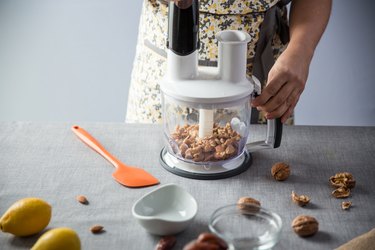 Woman using a food processor in the kitchen