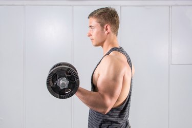 Man performing biceps curl.