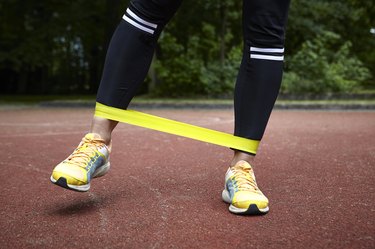 close-up of the legs of a woman doing the lateral band as a glute medius exercise