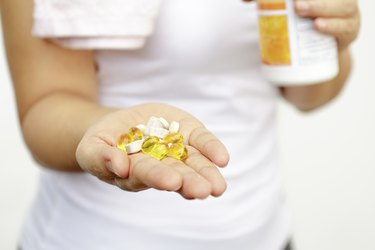 sport and diet concept - woman hand with medication