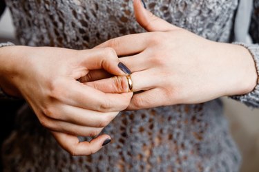 woman takes off a ring