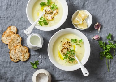 Potato cauliflower soup puree on a gray background, top view. Vegetarian healthy food concept