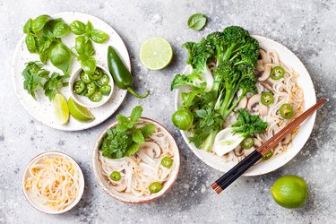 Vegetarian traditional Vietnamese soup Pho bo with herbs, rice noodles, broccolini, bok choy, bean sprouts, mushrooms. Vietnam national dish. Asian food concept.