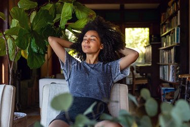 Young woman practicing deep breathing at home for a healthier life