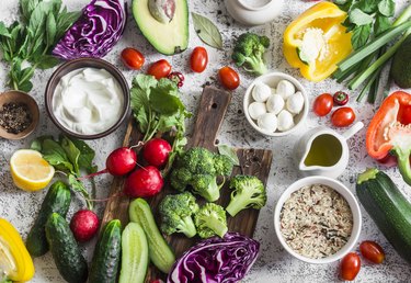 overhead shot of healthy foods for high bilirubin like broccoli and cucumbers that fit in a Mediterranean diet