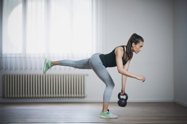 Person performing a single-leg Romanian deadlift in living room