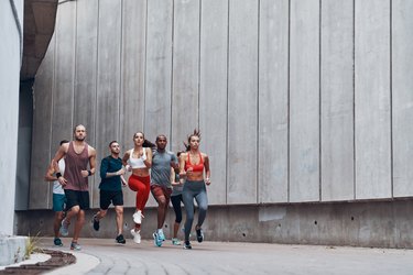 Full length rear view of people in sports clothing