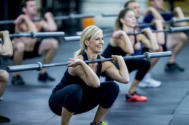 woman with a barbell doing a cold workout