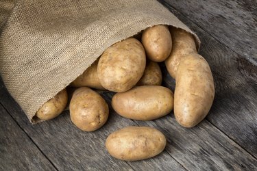 Russet Potatoes Spilling From Burlap Bag