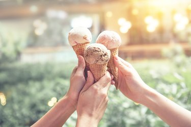 Young woman hands holding ice cream cones on summer