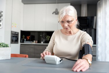 Senior Woman Checking Blood Pressure At Home
