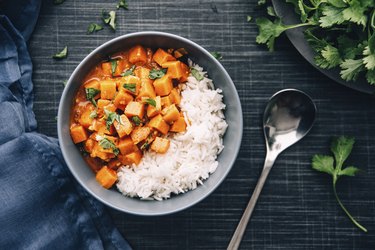 Bowl of sweet potato chunks with rice and sliver spoon