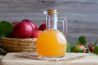 A bottle of raw unfiltered apple cider vinegar, as a natural remedy for eczema