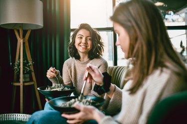 Two Cute Females Eating Salads Together