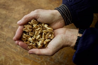 Hands holding walnuts