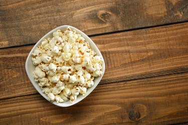 Bowl of Popcorn on Wood Background