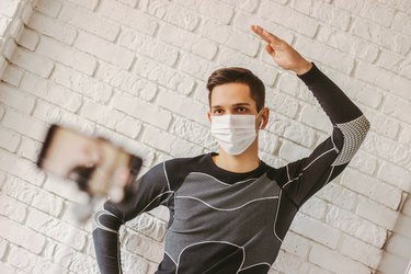 Sports man filming class with fitness exercises on camera