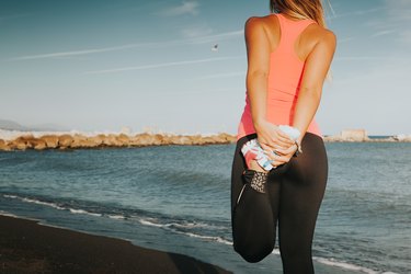 Woman leg stretching at the beach.