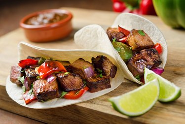 Beef fajitas with sauce and lime on the side