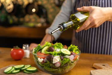 Chef pouring salad oil