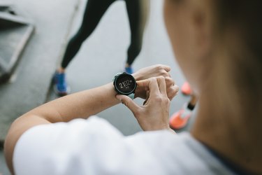 A woman checking her fitness tracker during a workout