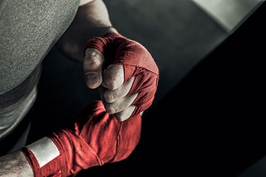 Closeup hand of boxer with red bandages