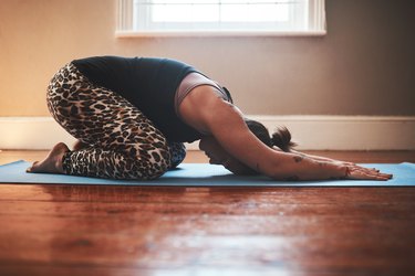 Woman performing child's pose for lower back mobility.