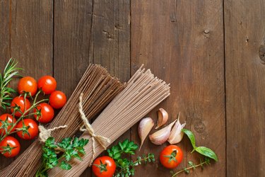 Three types of spaghetti, tomatoes and herbs
