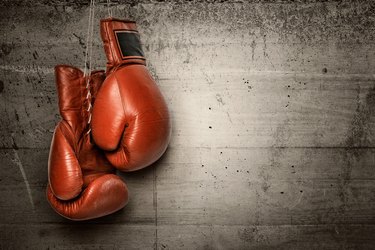 Boxing gloves hanging on concrete wall