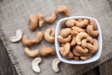 Salted cashew nuts in bowl on sackcloth