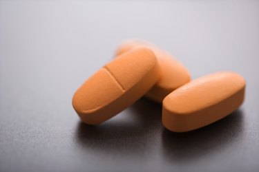 Three orange vitamin D tablets