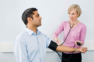 nurse taking patient's blood pressure to measure lisinopril medicine side effects