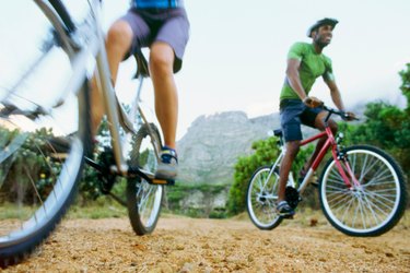 Low angle view of two people mountain biking