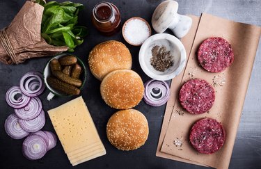 Raw beef meat burger cutlets with ingredients