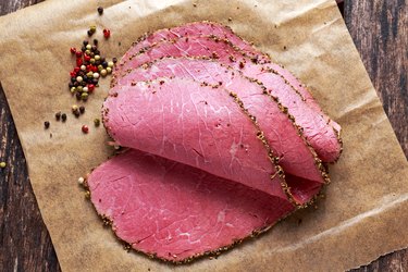 Peppered corned beef slices on paper