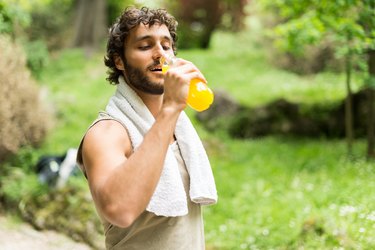 A man drinking a sports drink with electrolytes after a workout