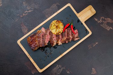 Beef steak sliced on dark concrete table