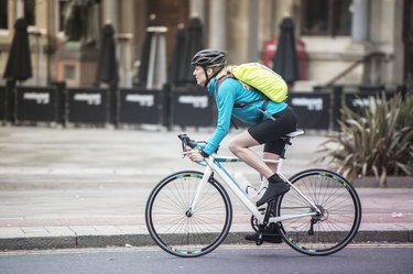 Woman commuting by bicycle on city street