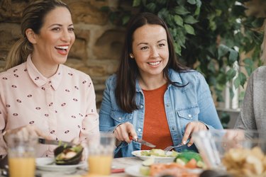 Friends following a low-carb diet eating lunch together