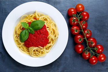 Spaghetti with marinara sauce and basil leaves on top