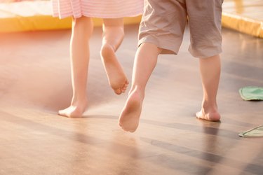 children's legs running on the trampoline