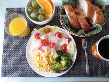 Scrambled egg breakfast with salad, fruit, coffee