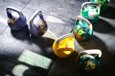 Kettlebells on a gym floor for a weight-lifting workout for weight loss
