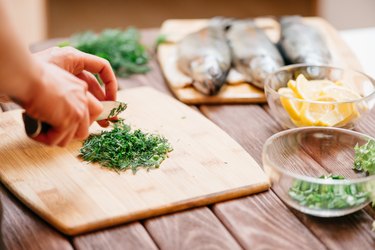 how to cook sea bass woman preparing seasonings for fish.