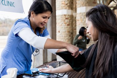 Nurse checks patient's blood pressure