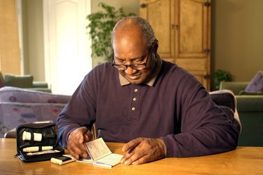 Man reading manual for blood test kit