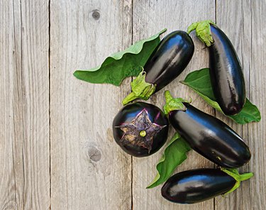 Ripe eggplants on a wooden background. Top view, flat lay.